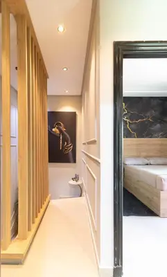 a hallway leading to a bedroom with a bed at Duplex Chic & Design Unique au bord de la mer ! in Mohammedia