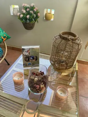 a glass table with a bowl of food and candles on it at Duplex Chic & Design Unique au bord de la mer ! in Mohammedia