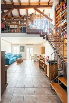 a living room with a spiral staircase and a living room at Maison du bonheur in Casablanca