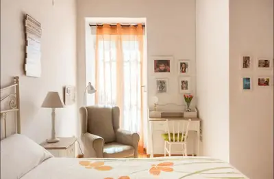 a bedroom with a bed and a chair and a desk at Maison du bonheur in Casablanca