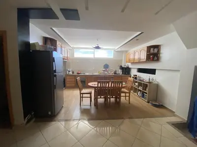 a kitchen with a table and chairs and a refrigerator at duplex in Oulad Lahsene