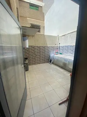 a room with a room with a tile floor at duplex in Oulad Lahsene