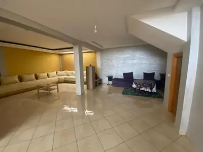 a large living room with couches and a fireplace at duplex in Oulad Lahsene