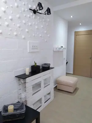 a bathroom with a white wall with a counter at Sweet Home in Casablanca