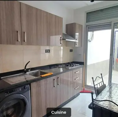 a kitchen with a sink and a washing machine at Luxury apartment in Casablanca