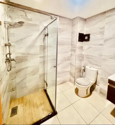 a bathroom with a shower and a toilet at Residence GYA Beach - Luxe Moderne et Confort à Harhoura accès plage in Temara