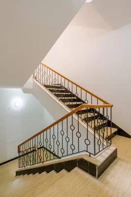 a staircase in a building with wooden floors and a stair case at Residence GYA Beach - Luxe Moderne et Confort à Harhoura accès plage in Temara