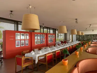 a dining room with long tables and chairs at Residence GYA Beach - Luxe Moderne et Confort à Harhoura accès plage in Temara
