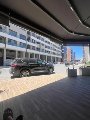 a car parked in a parking lot in front of a building at Bel appartement in Casablanca