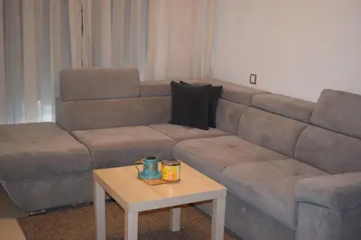 a living room with a couch and a coffee table at Appartement Confortable en Résidence Privée avec Piscine in Pont Blondin