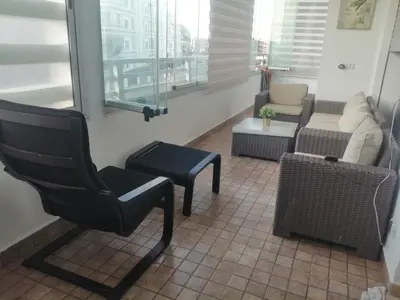 a living room with a chair and a couch at Appartement Confortable en Résidence Privée avec Piscine in Pont Blondin