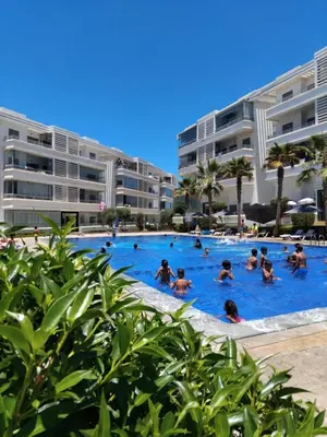 a group of people in a swimming pool at a resort at Appartement Confortable en Résidence Privée avec Piscine in Pont Blondin