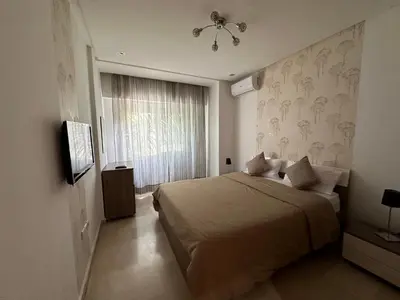 a bedroom with a large bed and a window at Ricks appartement in Casablanca