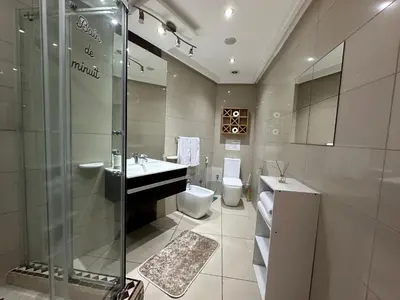 a bathroom with a shower and a sink and a toilet at Ricks appartement in Casablanca