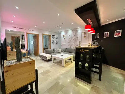 a living room with a couch and a table at Ricks appartement in Casablanca