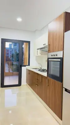 a kitchen with a stove and a microwave at Cosy Suite Appart in Kasba Bou Hamira