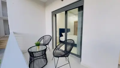 a group of chairs and a table on a balcony at Cosy Suite Appart in Kasba Bou Hamira