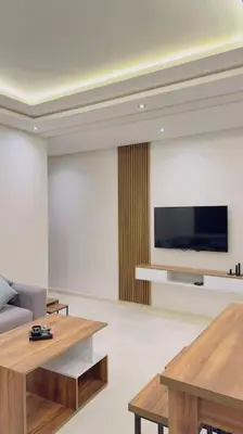 a living room with two tables and a flat screen tv at Cosy Suite Appart in Kasba Bou Hamira
