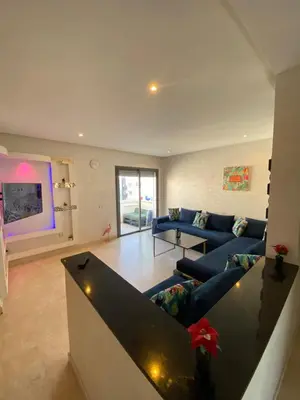 a living room with a couch and a table at Paradise beach in Mansouria
