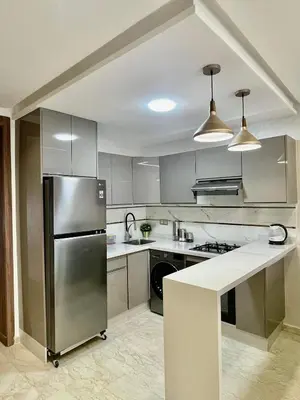 a kitchen with a stainless steel refrigerator and a counter at Appartement cosy in Casablanca