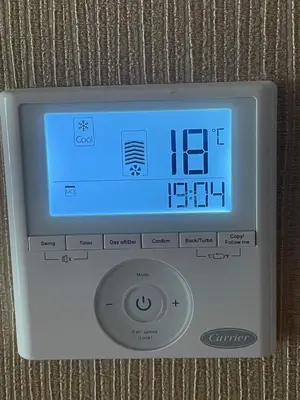 an electronic clock on a wall in a room at Appartement cosy in Casablanca