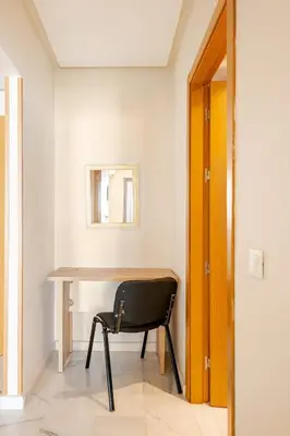 a chair sits in front of a desk in a room at AS140 élégant coeur de Casablanca avec Wifi Parking et Tramway in Casablanca