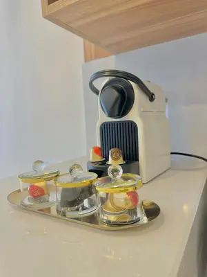 a tea set on a tray next to a coffee maker at AS140 élégant coeur de Casablanca avec Wifi Parking et Tramway in Casablanca