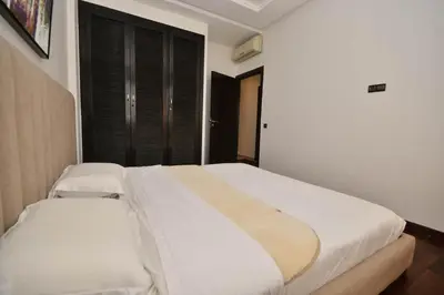 a bedroom with a large bed with white sheets at Lovely 2 bedroom flat in Ain Diab in Casablanca