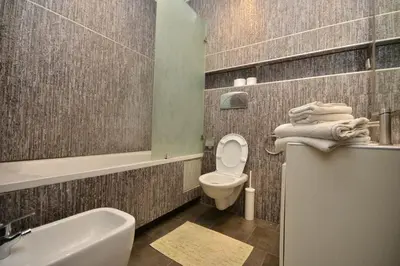a bathroom with a toilet and a sink and a tub at Lovely 2 bedroom flat in Ain Diab in Casablanca