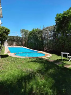a swimming pool in the yard of a house at Lovely 2 bedroom flat in Ain Diab in Casablanca