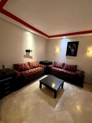 a living room with a couch and a table at Votre chez-vous à Casa, une ambiance cosy garantie in Casablanca