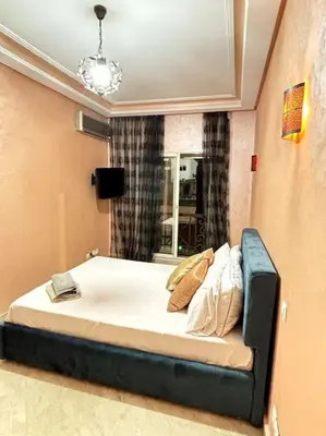 a bedroom with a large bed with a window at Votre chez-vous à Casa, une ambiance cosy garantie in Casablanca
