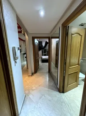 a hallway of a room with a door and a bathroom at Votre chez-vous à Casa, une ambiance cosy garantie in Casablanca