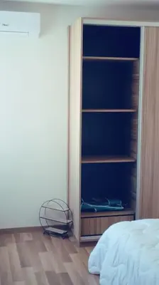 a bedroom with a book shelf next to a bed at Maarif dar zara 2 chambres ,Wifi ,Parking Gratuit in Casablanca