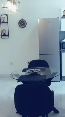 a room with two chairs and a glass table at Maarif dar zara 2 chambres ,Wifi ,Parking Gratuit in Casablanca
