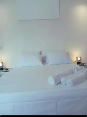 a white bed with two rolled up towels on it at Maarif dar zara 2 chambres ,Wifi ,Parking Gratuit in Casablanca