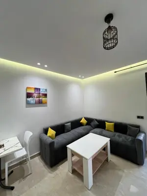 a living room with a couch and a table at Studio en plein centre de Casablanca in Casablanca
