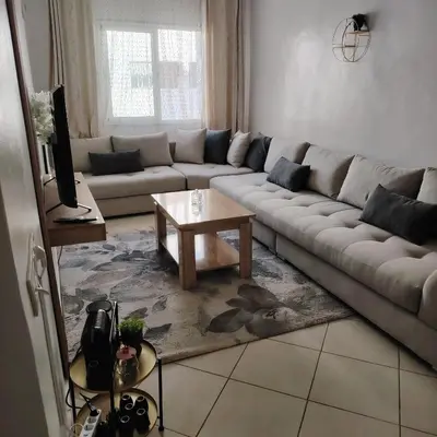 a living room with a couch and a coffee table at Élégance familiale à Skhirate près de la plage et la ville in Skhirat