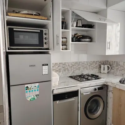 a kitchen with a refrigerator and a washer and dryer at Élégance familiale à Skhirate près de la plage et la ville in Skhirat