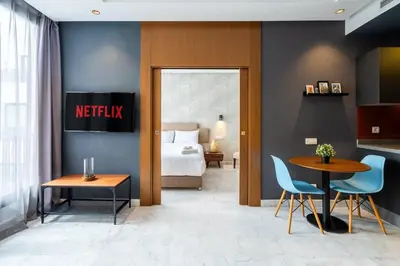 a hotel room with a bed and a table and chairs at Studio Raffiné en Centre Ville in Casablanca