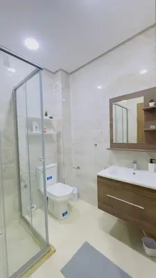 a bathroom with a shower and a toilet and a sink at Cosy Suite Appart in Bouznika