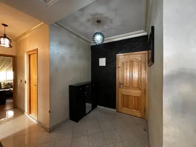 a hallway of a house with a wooden door at Appartement à 5min de Casanearshore in Casablanca