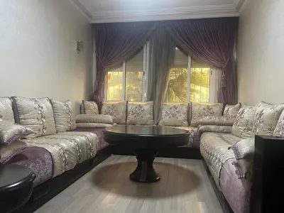 a living room with a couch and a table at Appartement à 5min de Casanearshore in Casablanca