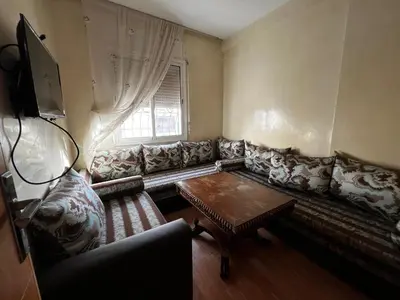 a living room with a couch and a table at Appartement à 5min de Casanearshore in Casablanca