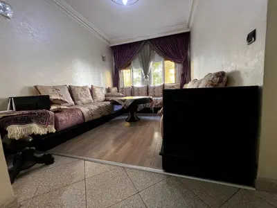 a living room with a couch and a table at Appartement à 5min de Casanearshore in Casablanca