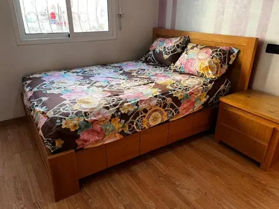 a small bed with a floral comforter in a bedroom at Appartement à 5min de Casanearshore in Casablanca