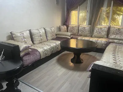 a living room with a couch and a table at Appartement à 5min de Casanearshore in Casablanca