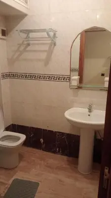 a bathroom with a sink and a toilet and a mirror at Appartement à Maarif in Casablanca