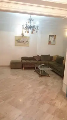 a living room with a couch and a table at Appartement à Maarif in Casablanca