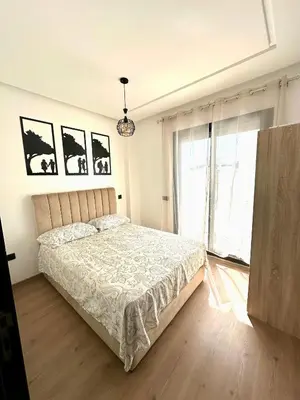 a bedroom with a bed and a large window at Alonso studio au coeur de Maarif in Casablanca